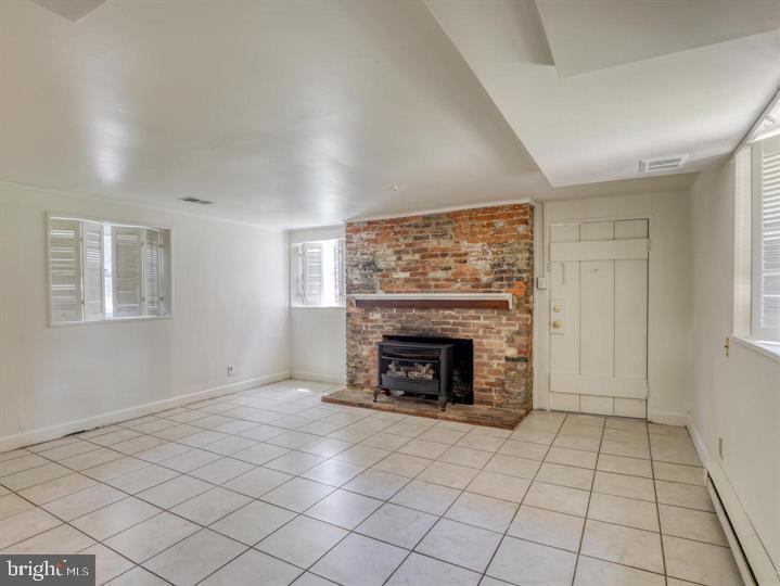103 North Church Street Berryville, VA 22611 - Photo 5 of 13 a view of an empty room with a fireplace and window
