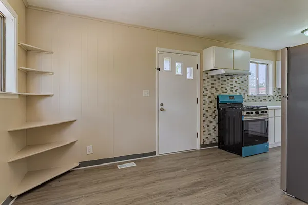 a kitchen with stainless steel appliances granite countertop a refrigerator and a stove top oven