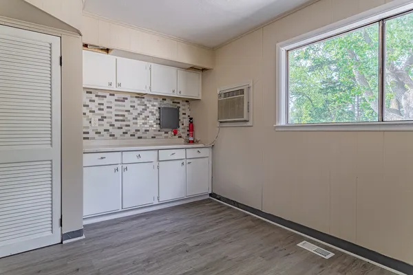 a kitchen with a sink window and cabinets