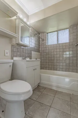 a bathroom with a sink a toilet and bathtub