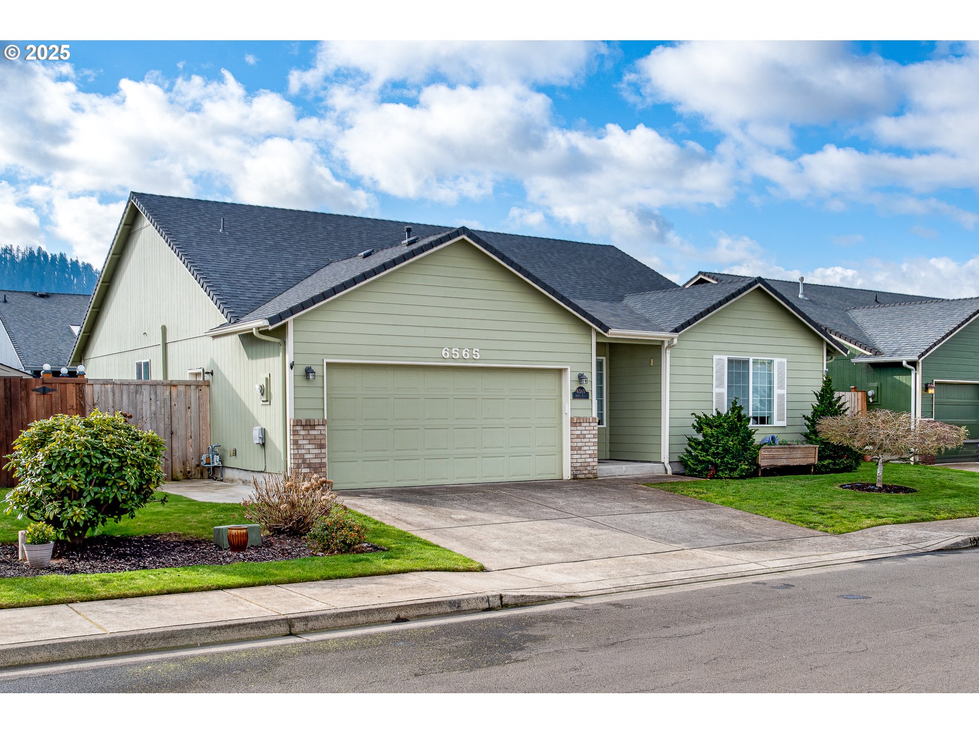 6565 Aaron Lane Springfield, OR 97478 - Photo 1 of 48 a front view of a house with a yard and garage