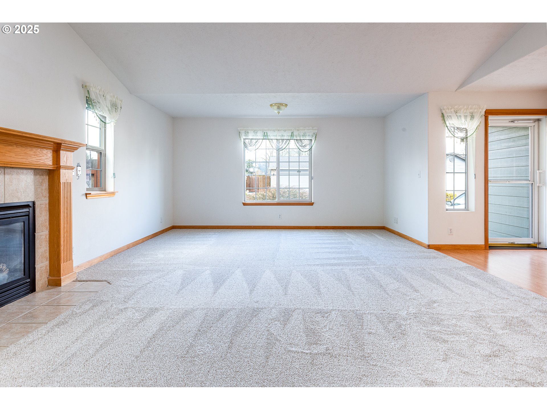 6565 Aaron Lane Springfield, OR 97478 - Photo 11 of 48 a view of an empty room with a window and wooden floor