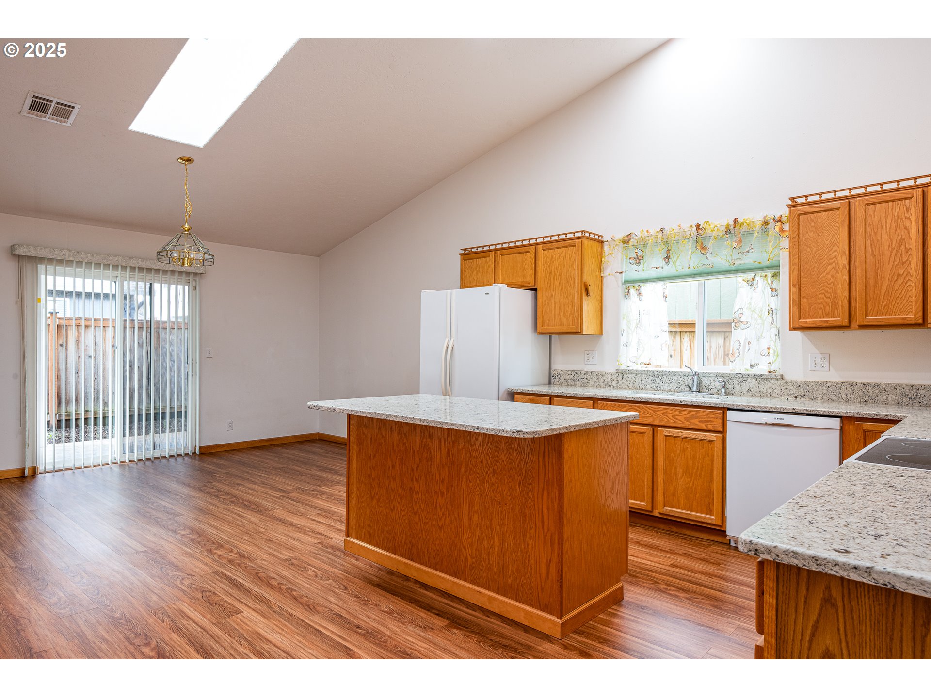 6565 Aaron Lane Springfield, OR 97478 - Photo 14 of 48 a kitchen with stainless steel appliances granite countertop a sink dishwasher a stove with wooden floor