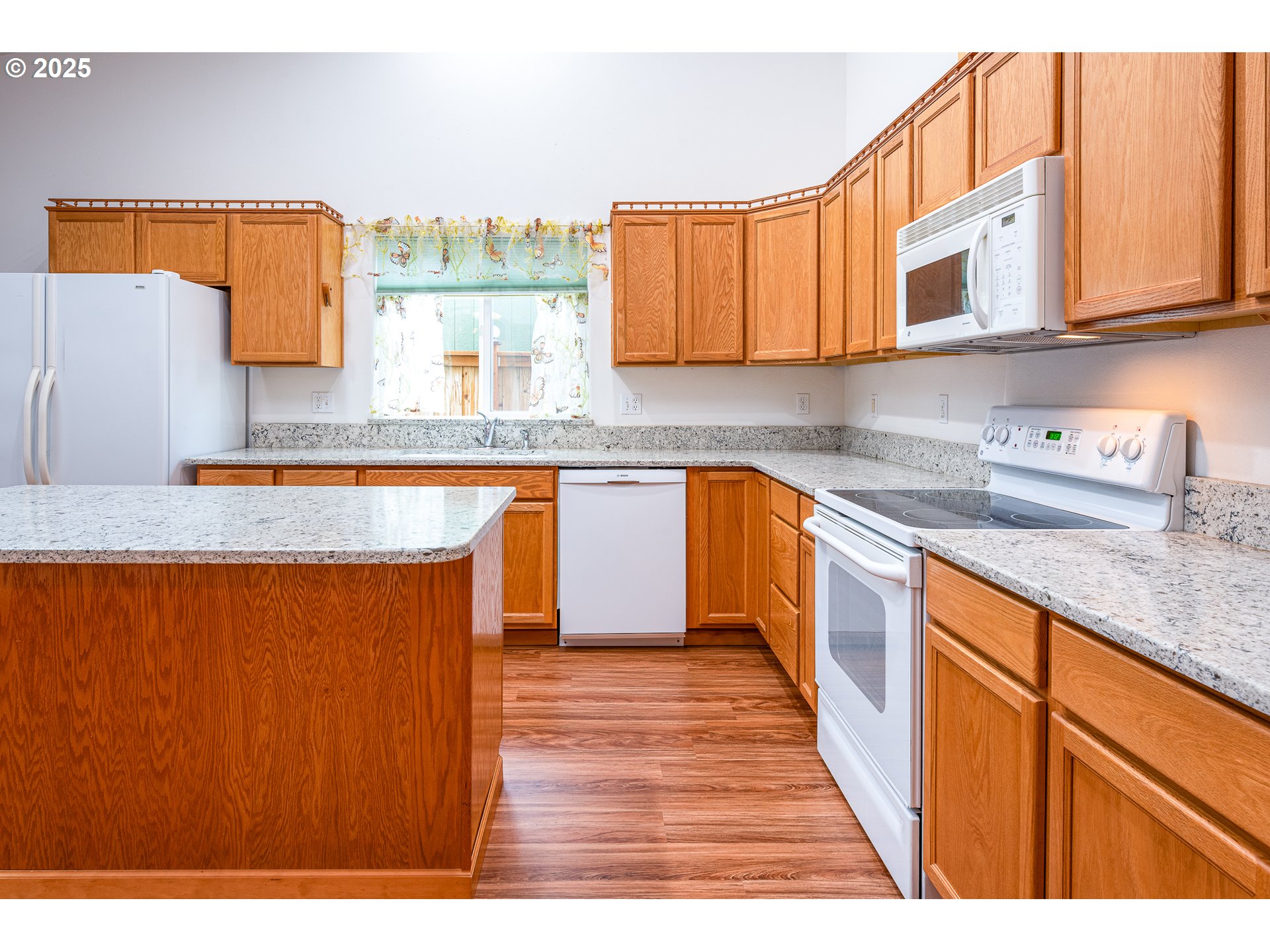 6565 Aaron Lane Springfield, OR 97478 - Photo 15 of 48 a kitchen with stainless steel appliances granite countertop a sink and a microwave