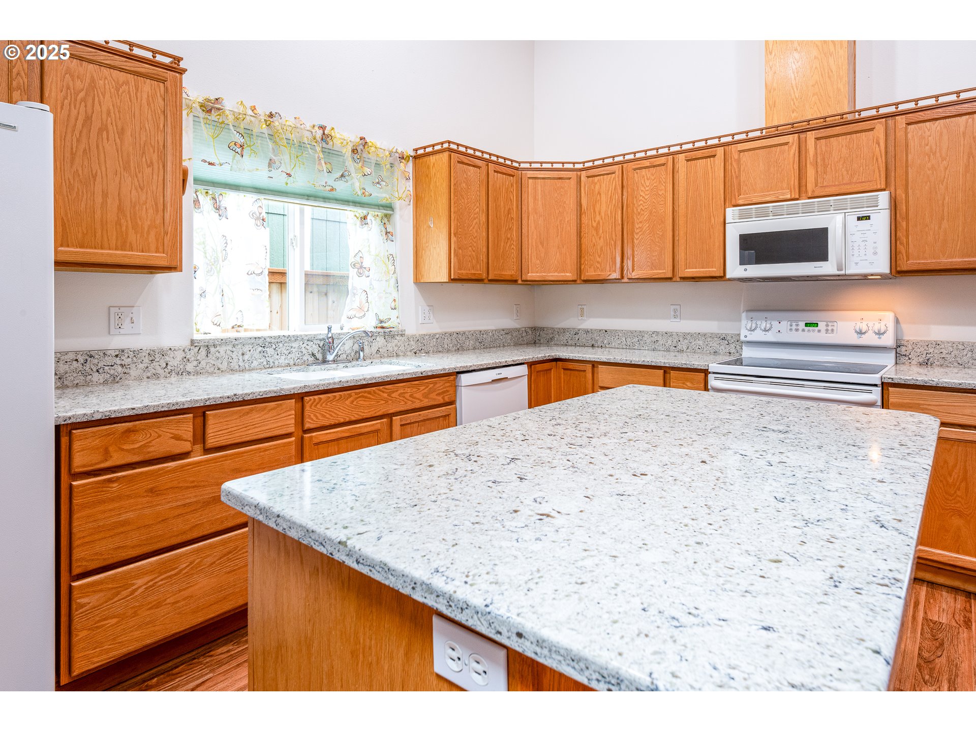 6565 Aaron Lane Springfield, OR 97478 - Photo 16 of 48 a kitchen with stainless steel appliances kitchen island granite countertop a sink and cabinets