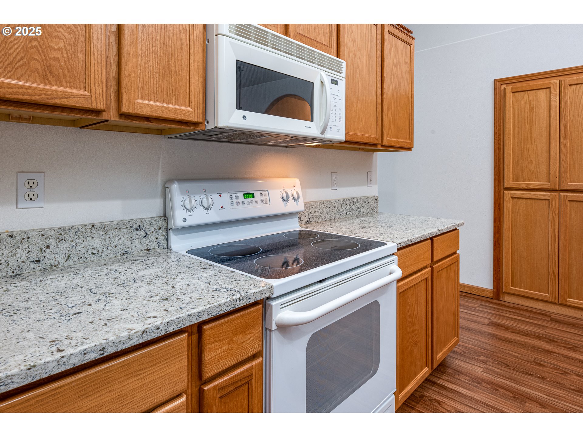 6565 Aaron Lane Springfield, OR 97478 - Photo 19 of 48 a kitchen with granite countertop a sink a stove and cabinets