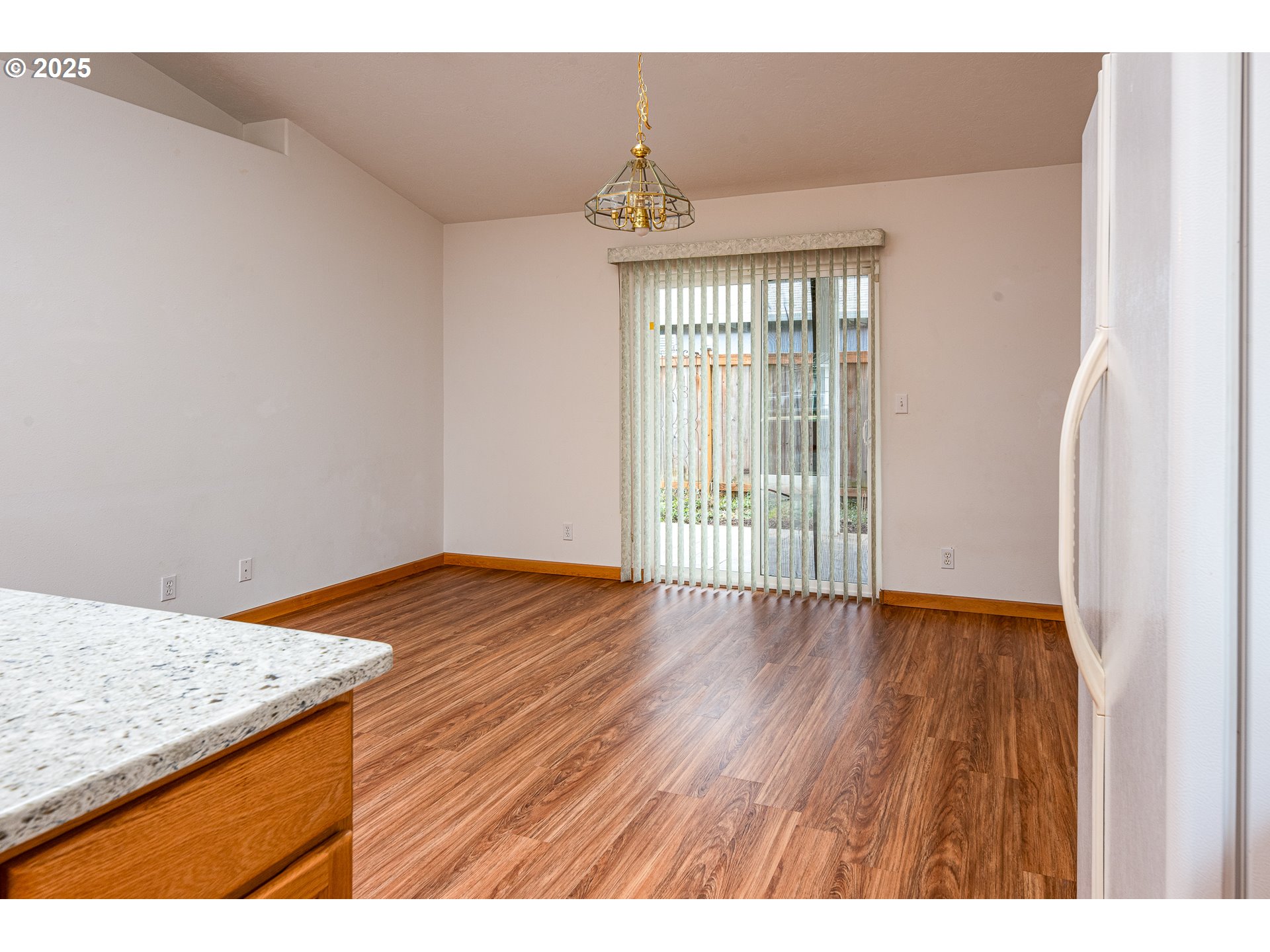 6565 Aaron Lane Springfield, OR 97478 - Photo 21 of 48 a view of an empty room with wooden floor and a window