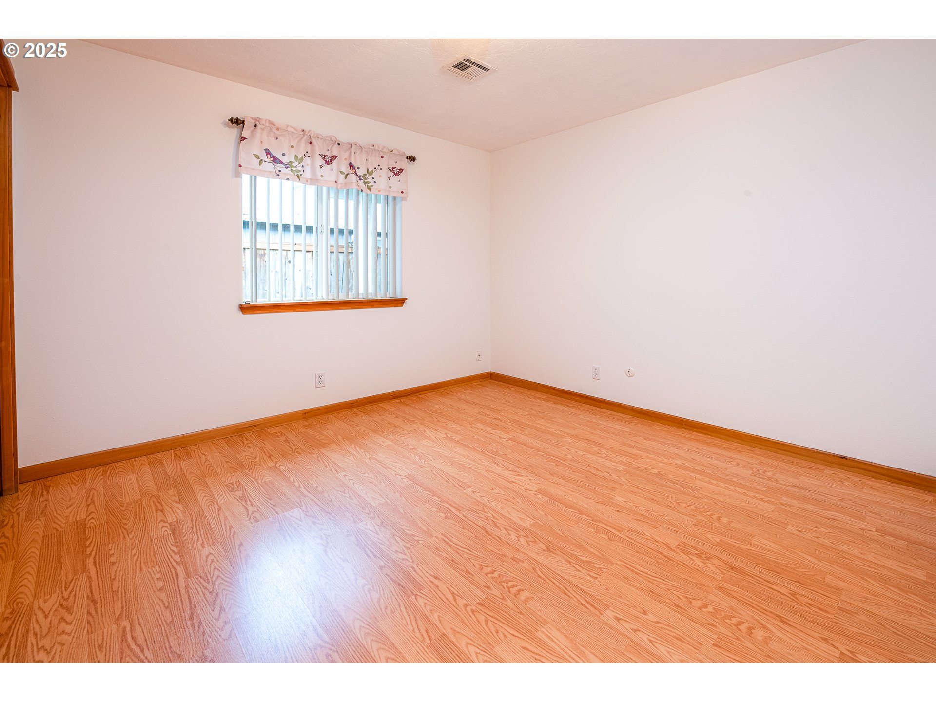 6565 Aaron Lane Springfield, OR 97478 - Photo 28 of 48 a view of an empty room with wooden floor and a window