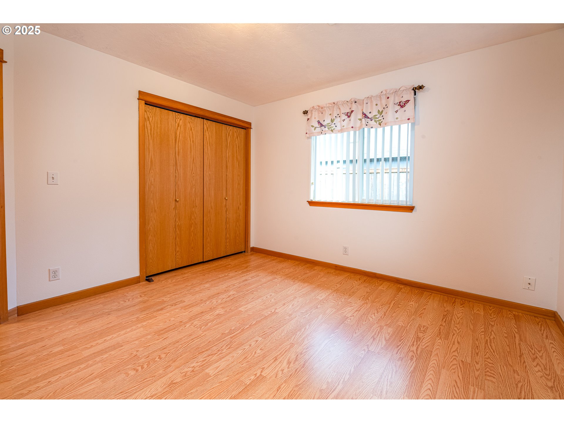 6565 Aaron Lane Springfield, OR 97478 - Photo 29 of 48 an empty room with wooden floor and windows