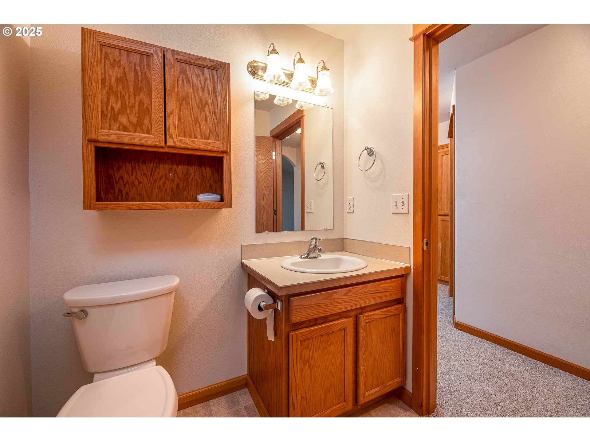 6565 Aaron Lane Springfield, OR 97478 - Photo 31 of 48 a bathroom with a sink a toilet and mirror