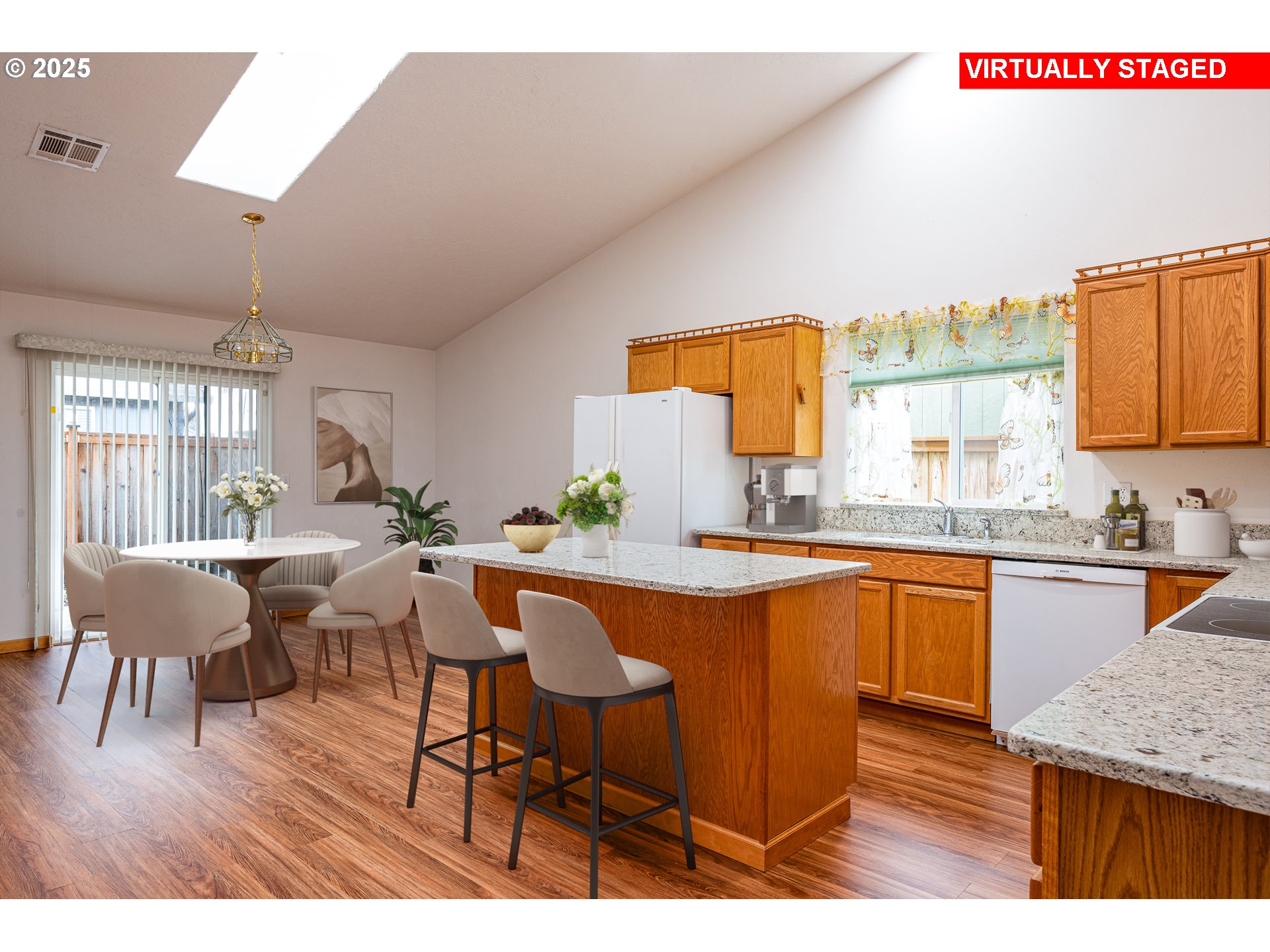 6565 Aaron Lane Springfield, OR 97478 - Photo 5 of 48 a kitchen with stainless steel appliances granite countertop a table chairs and a wooden floor