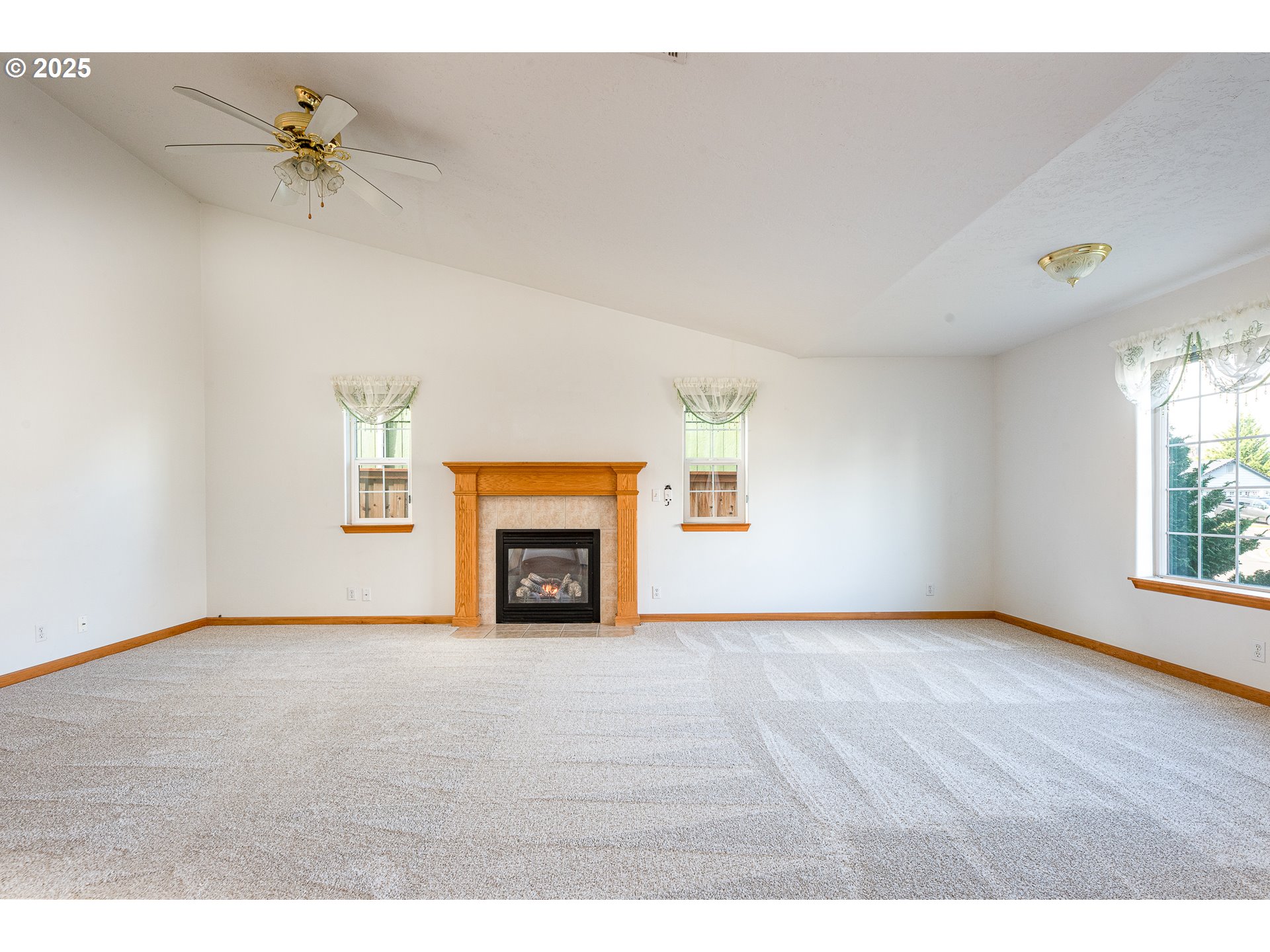 6565 Aaron Lane Springfield, OR 97478 - Photo 9 of 48 a view of an empty room with a window and a fireplace