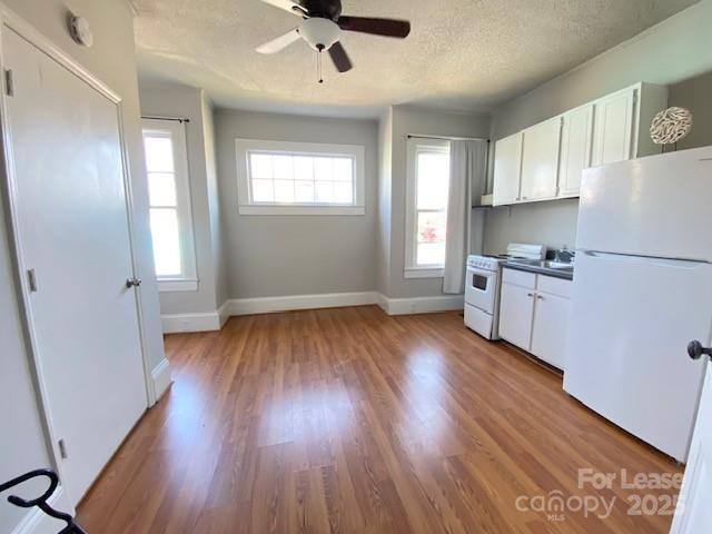 823 Central Avenue Charlotte, NC 28204 - Photo 6 of 14 a kitchen with wooden floors and white walls