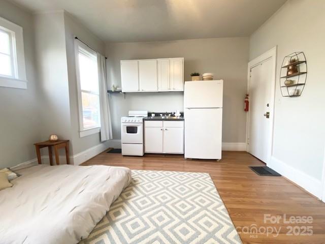 823 Central Avenue Charlotte, NC 28204 - Photo 9 of 14 a bedroom with a bed and white cabinets