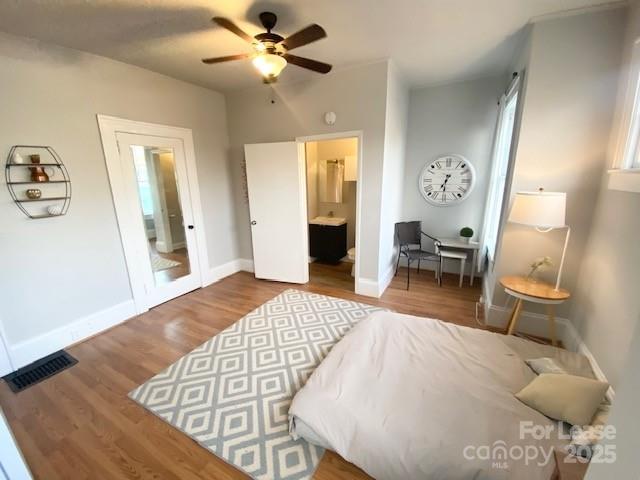 823 Central Avenue Charlotte, NC 28204 - Photo 10 of 14 a bedroom with a bed and wooden floor