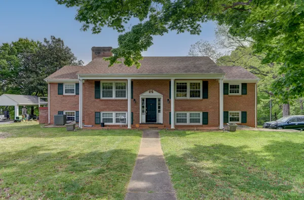 a front view of a house with a garden