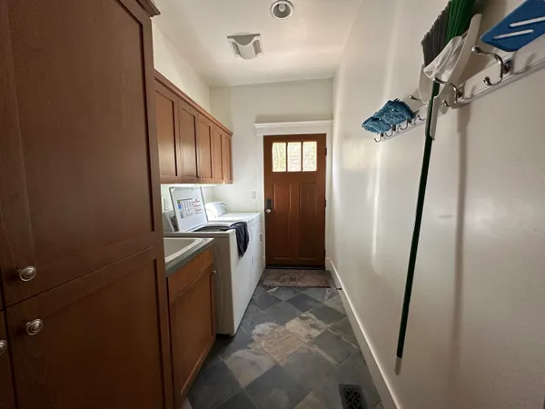 a bathroom with sink a washer and dryer
