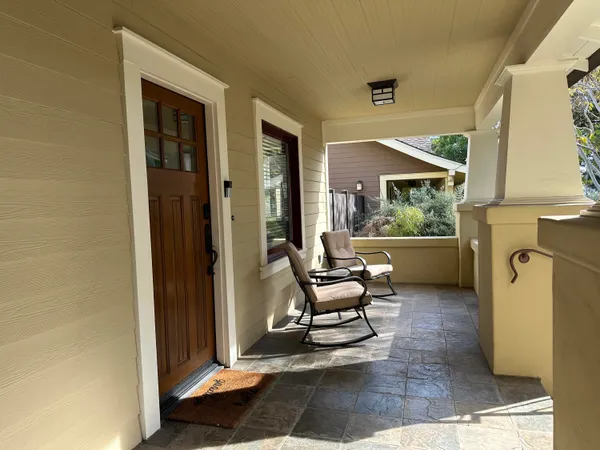 a living room with furniture a window and a painting