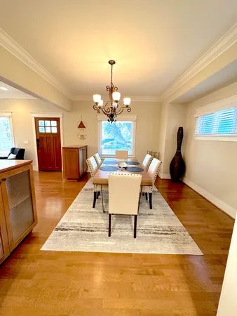 a living room with furniture a chandelier and a rug
