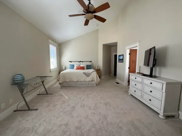 a bedroom with furniture and a flat screen tv