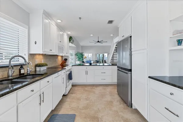 a large kitchen with stainless steel appliances lots of counter space and a sink