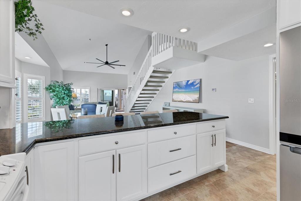 11000 Placida Road, Unit 1603 Placida, FL 33946 - Photo 11 of 34 a kitchen with granite countertop a white cabinets and sink