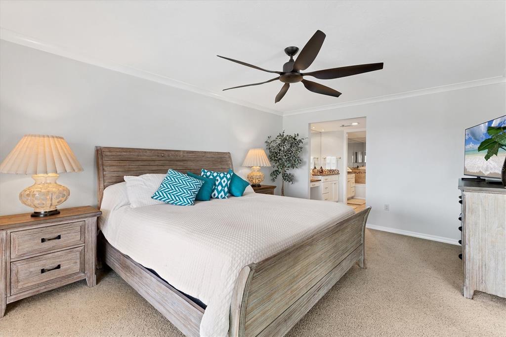 11000 Placida Road, Unit 1603 Placida, FL 33946 - Photo 14 of 44 a bedroom with a bed and a chandelier