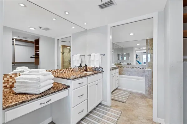 a large bathroom with a granite countertop sink and a mirror