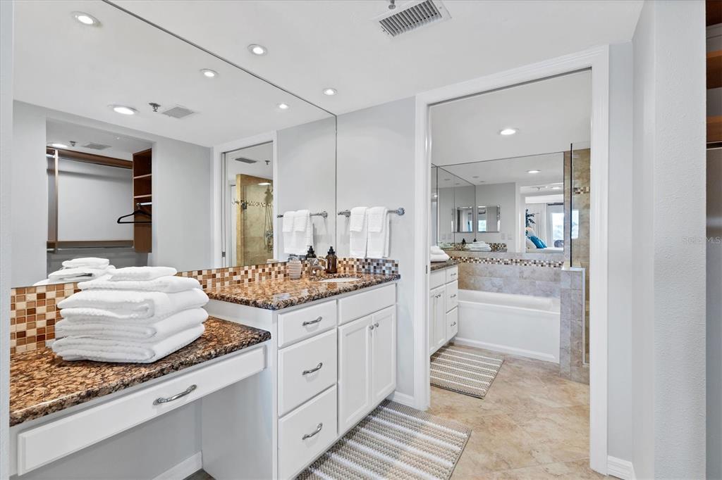 11000 Placida Road, Unit 1603 Placida, FL 33946 - Photo 15 of 44 a large bathroom with a granite countertop sink and a mirror