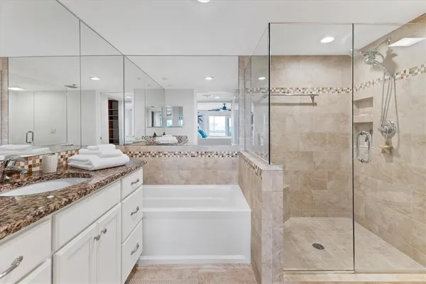 a bathroom with a granite countertop sink mirror and shower