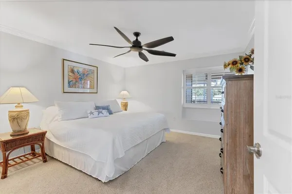 a bedroom with a bed and a painting on the wall
