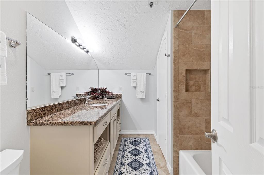 11000 Placida Road, Unit 1603 Placida, FL 33946 - Photo 22 of 44 a en suite bathroom with a granite countertop sink and a mirror