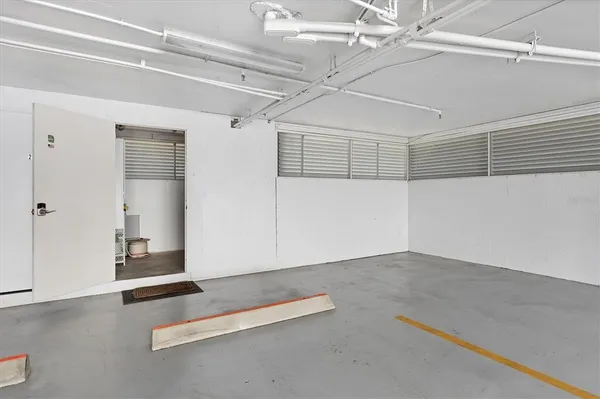 an empty room with a ceiling fan and wooden floor