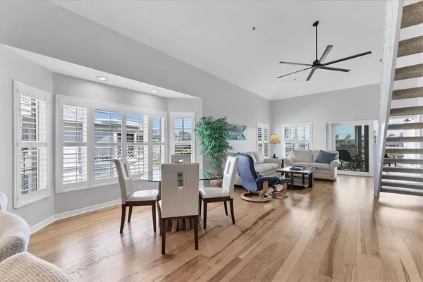 a living room with furniture dining table and a large window
