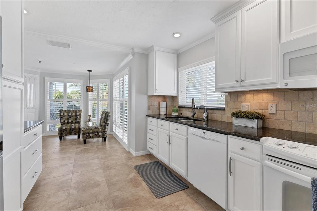 11000 Placida Road, Unit 1603 Placida, FL 33946 - Photo 9 of 44 a kitchen with white cabinets and refrigerator