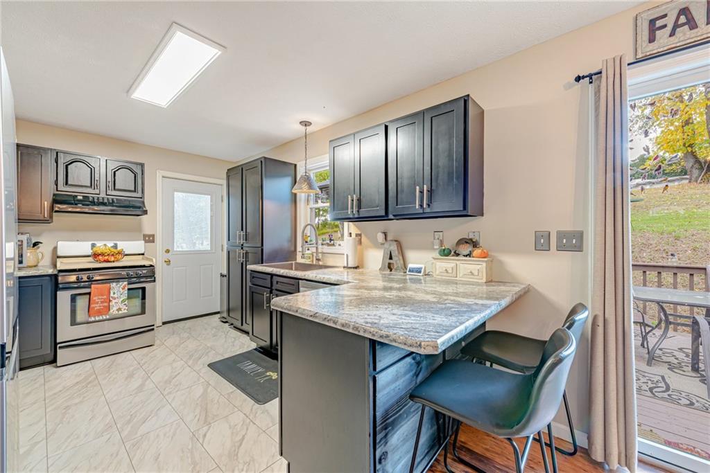 336 Parker Road Sarver, PA 16055 - Photo 13 of 21 a kitchen with a stove a sink and a refrigerator