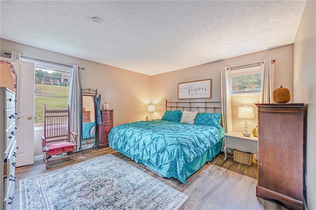 336 Parker Road Sarver, PA 16055 - Photo 6 of 21 a bedroom with a bed and dresser with wooden floor