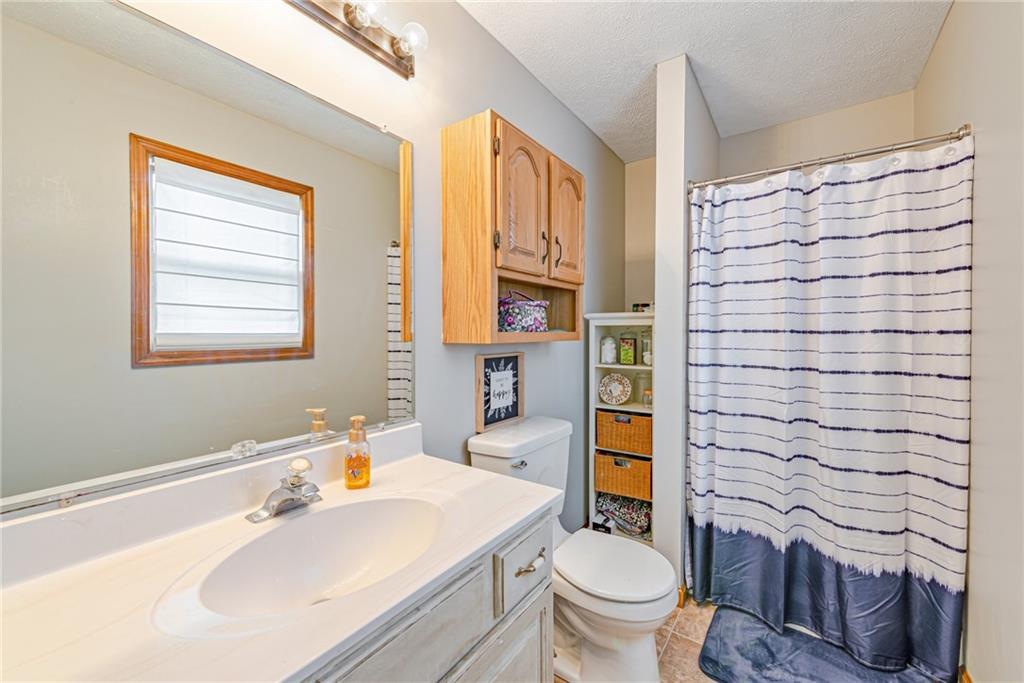 336 Parker Road Sarver, PA 16055 - Photo 7 of 21 a bathroom with a sink a toilet and shower curtain