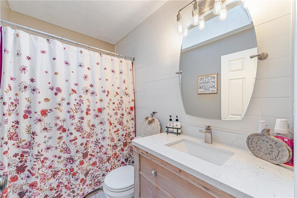 336 Parker Road Sarver, PA 16055 - Photo 10 of 21 a bathroom with a granite countertop sink a toilet and a mirror