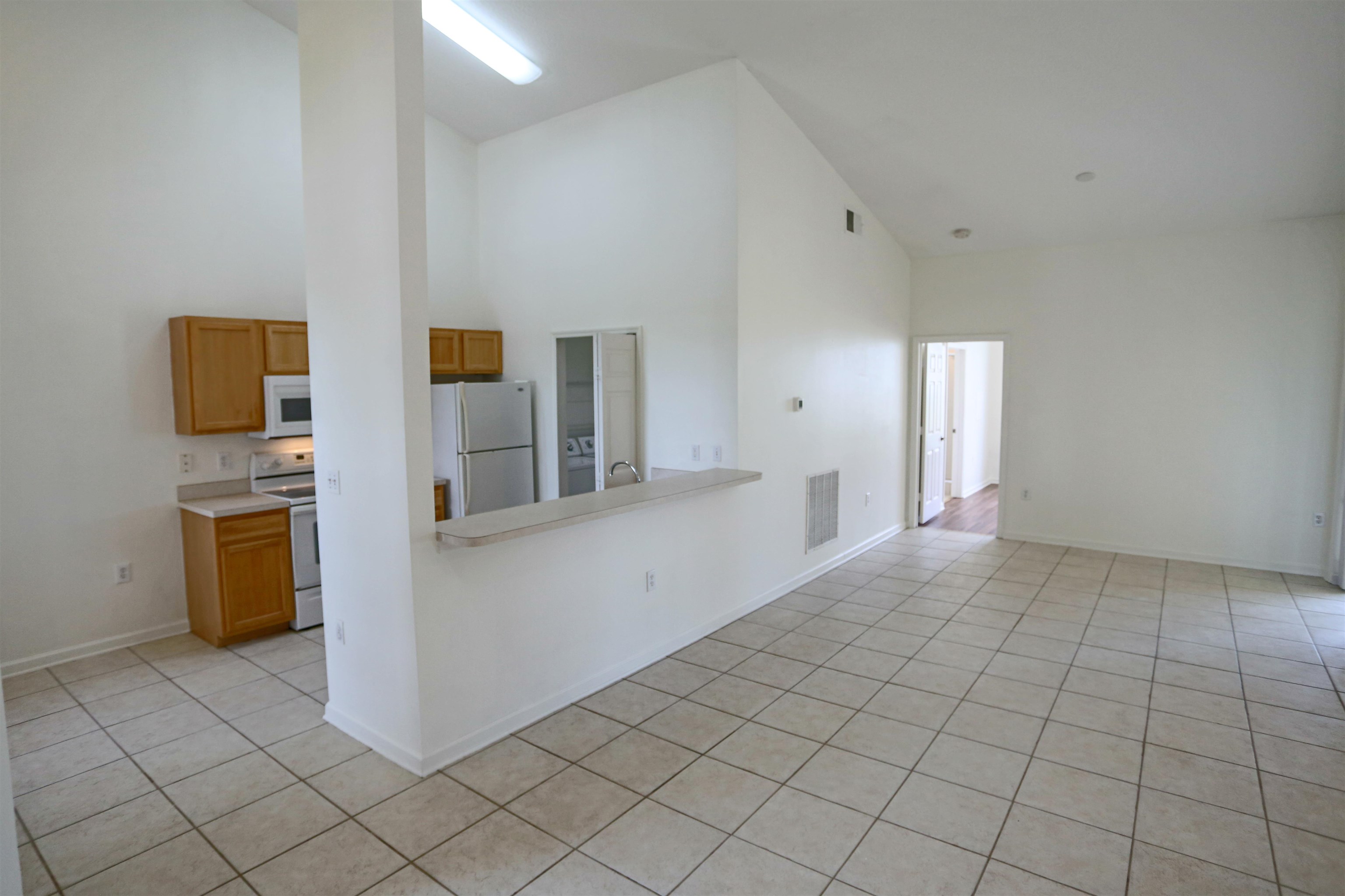 1603 Prestwick Place St. Augustine, FL 32086 - Photo 17 of 44 a view of a kitchen with furniture and an empty room
