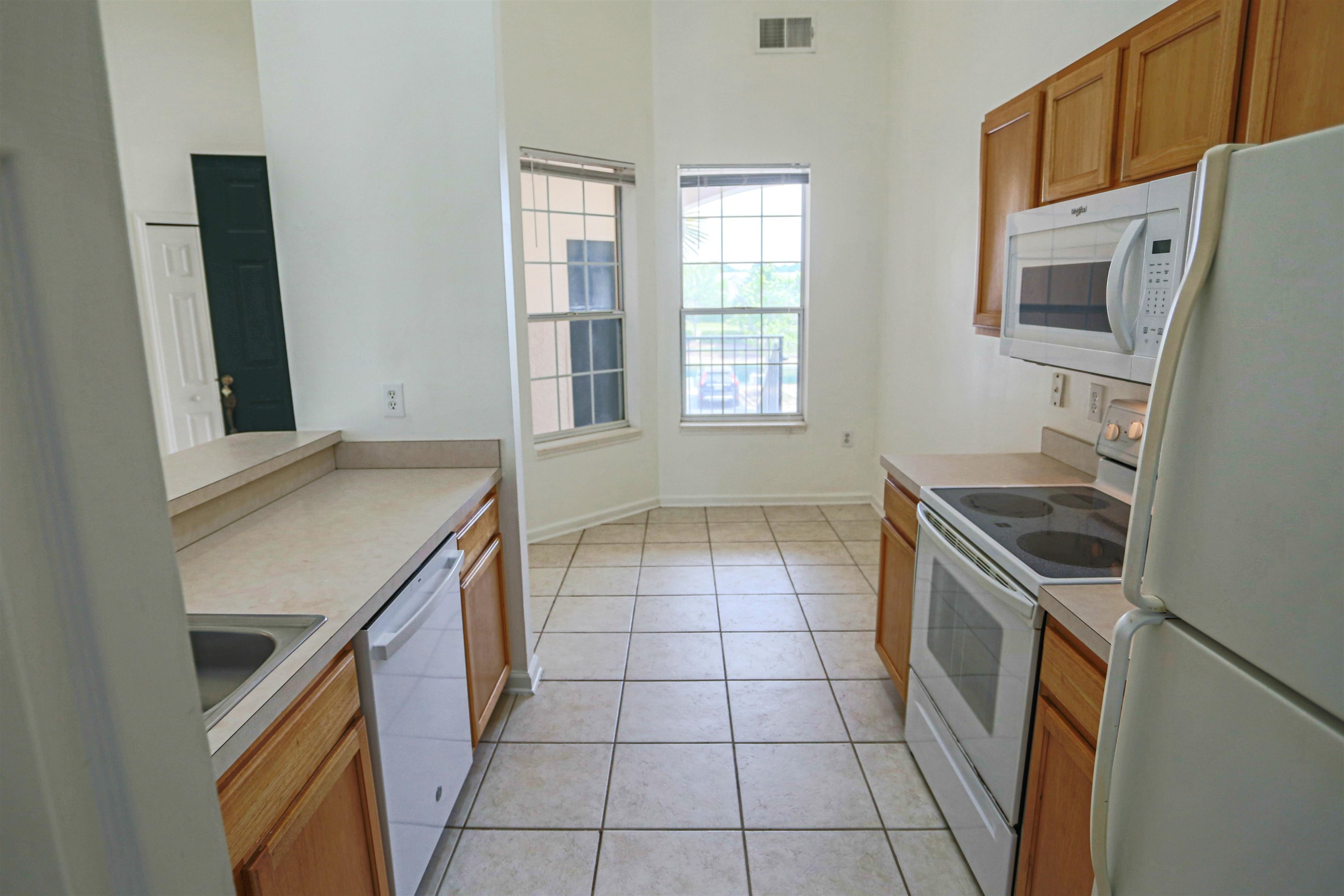 1603 Prestwick Place St. Augustine, FL 32086 - Photo 20 of 44 a kitchen with granite countertop a stove a sink and a refrigerator
