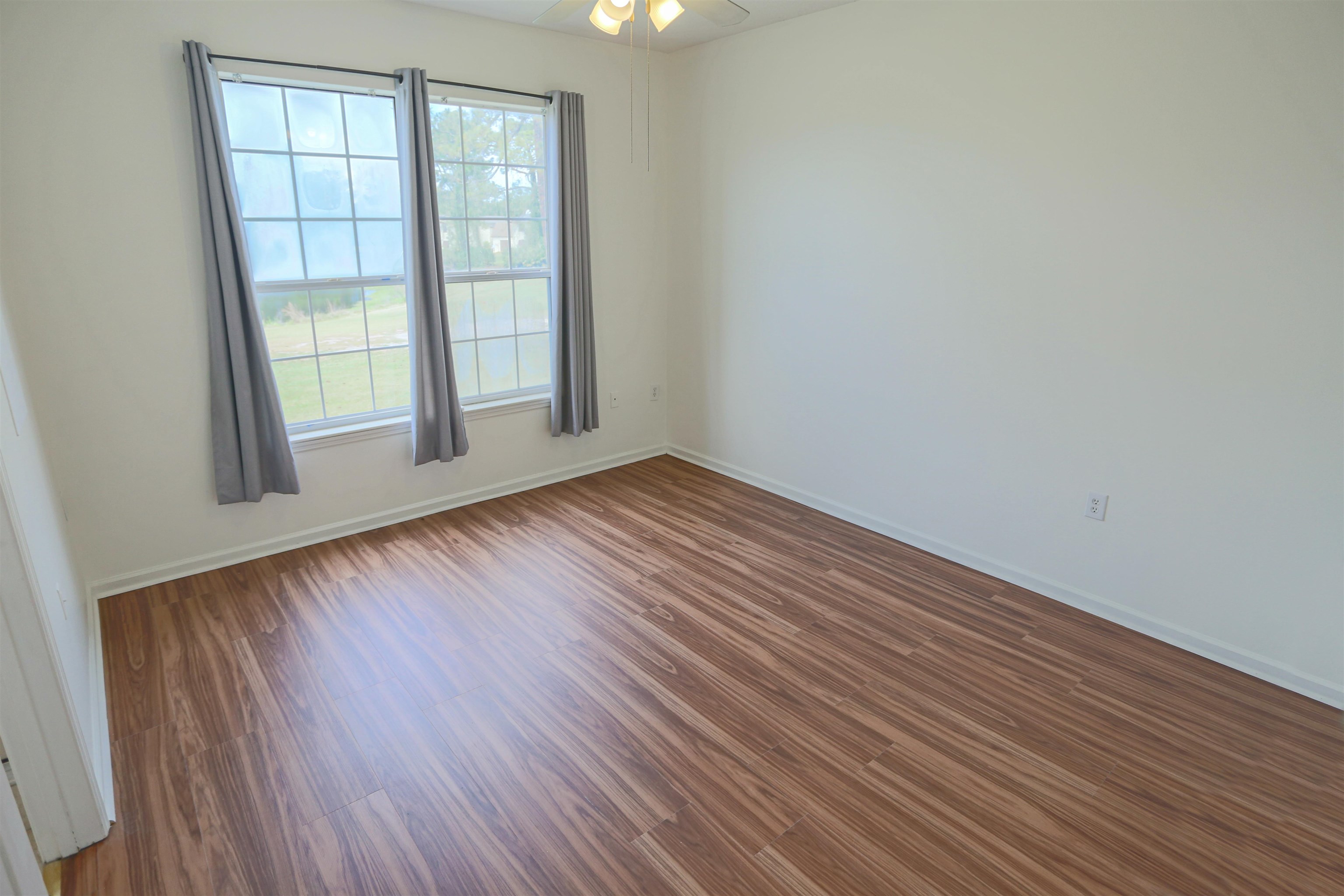 1603 Prestwick Place St. Augustine, FL 32086 - Photo 23 of 44 an empty room with wooden floor and windows