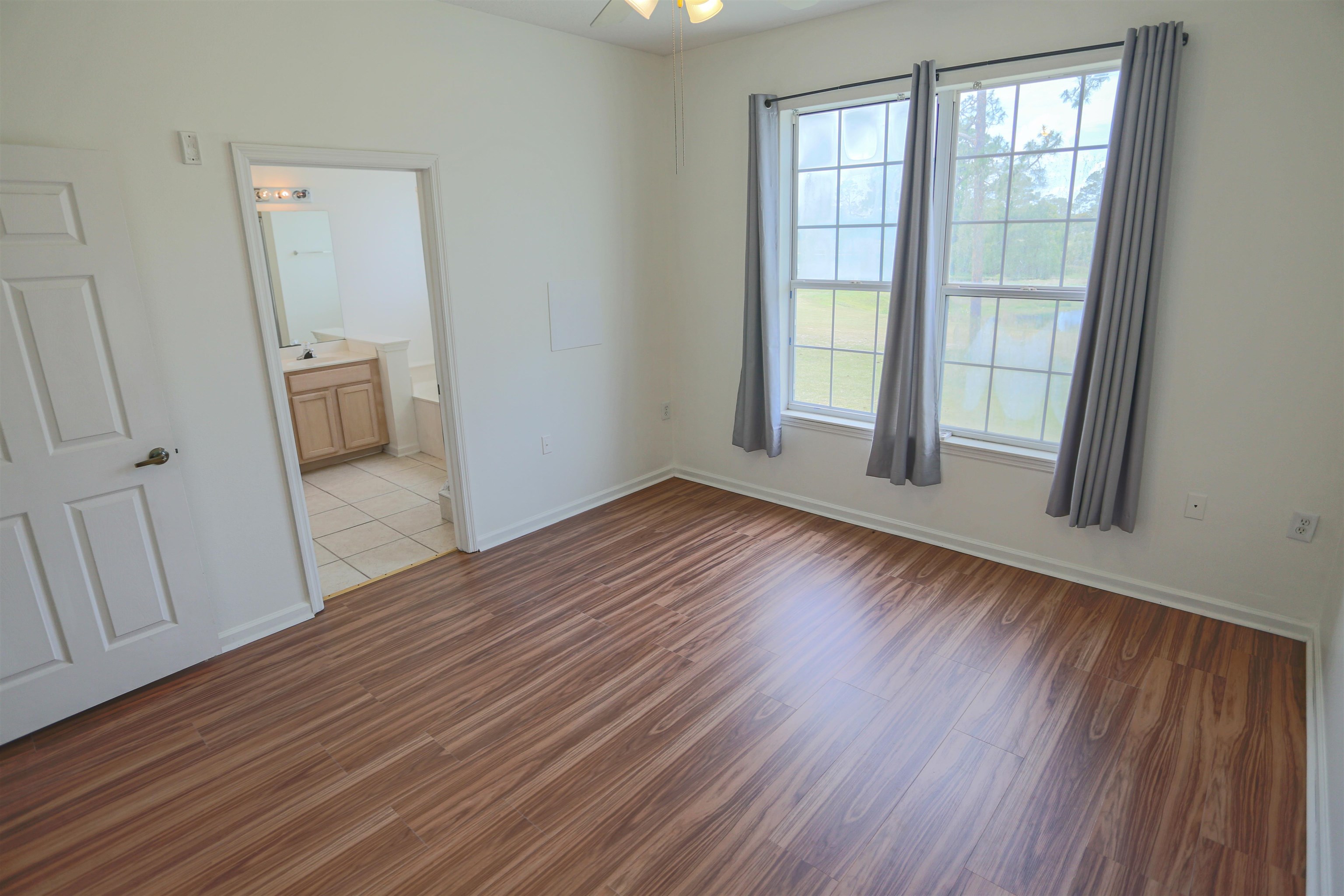 1603 Prestwick Place St. Augustine, FL 32086 - Photo 25 of 44 an empty room with wooden floor and windows