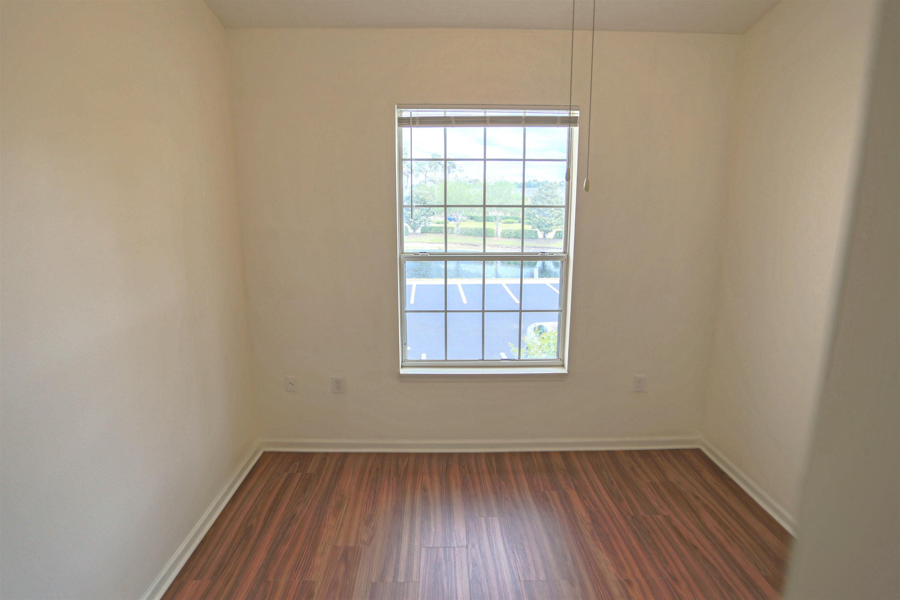 1603 Prestwick Place St. Augustine, FL 32086 - Photo 35 of 44 an empty room with wooden floor and windows