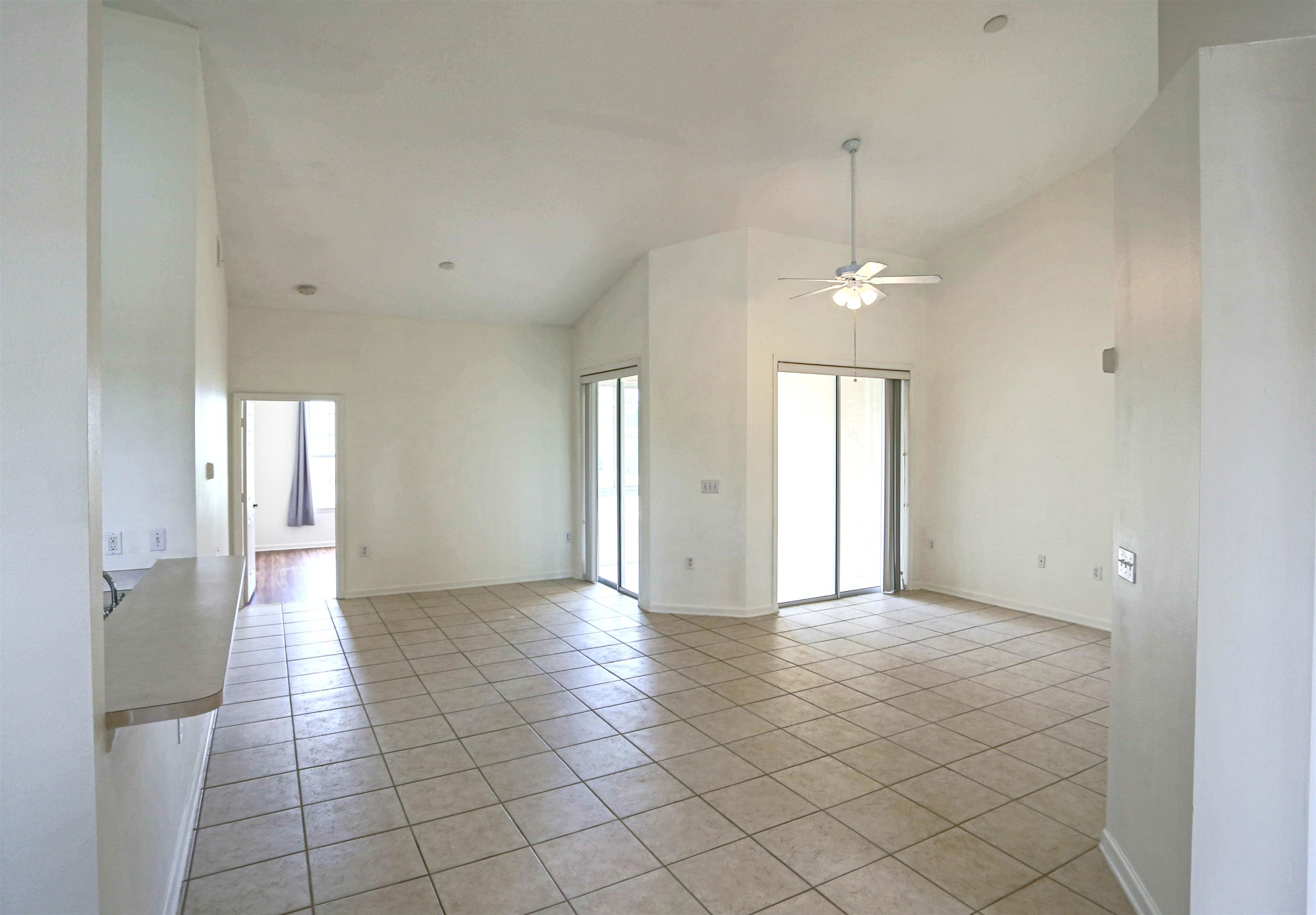 1603 Prestwick Place St. Augustine, FL 32086 - Photo 10 of 44 a view of an empty room with window and chandelier fan