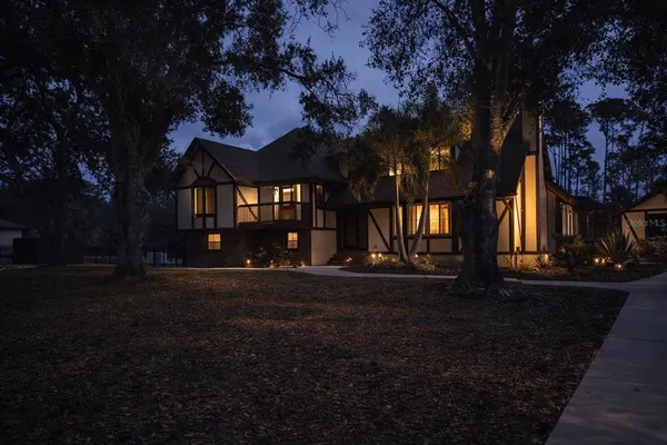 a view of empty room with wooden floor and fireplace