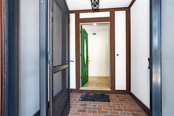 a view of empty room with wooden floor and fireplace