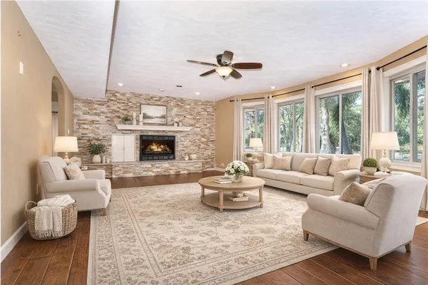 a living room with furniture flat screen tv and a fireplace