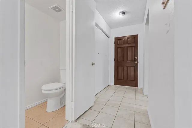 a living room with furniture a flat screen tv and a window