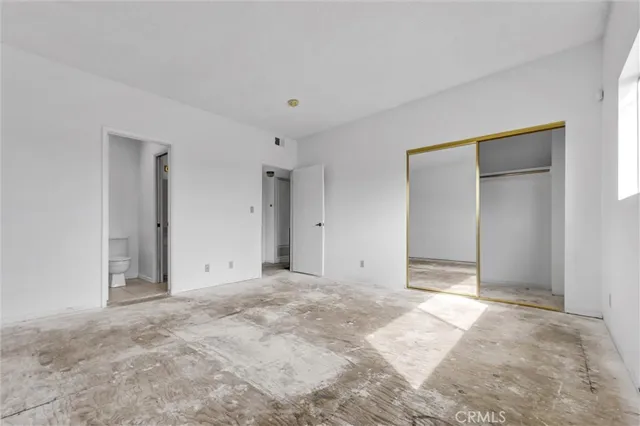 a white toilet sitting next to a bathroom